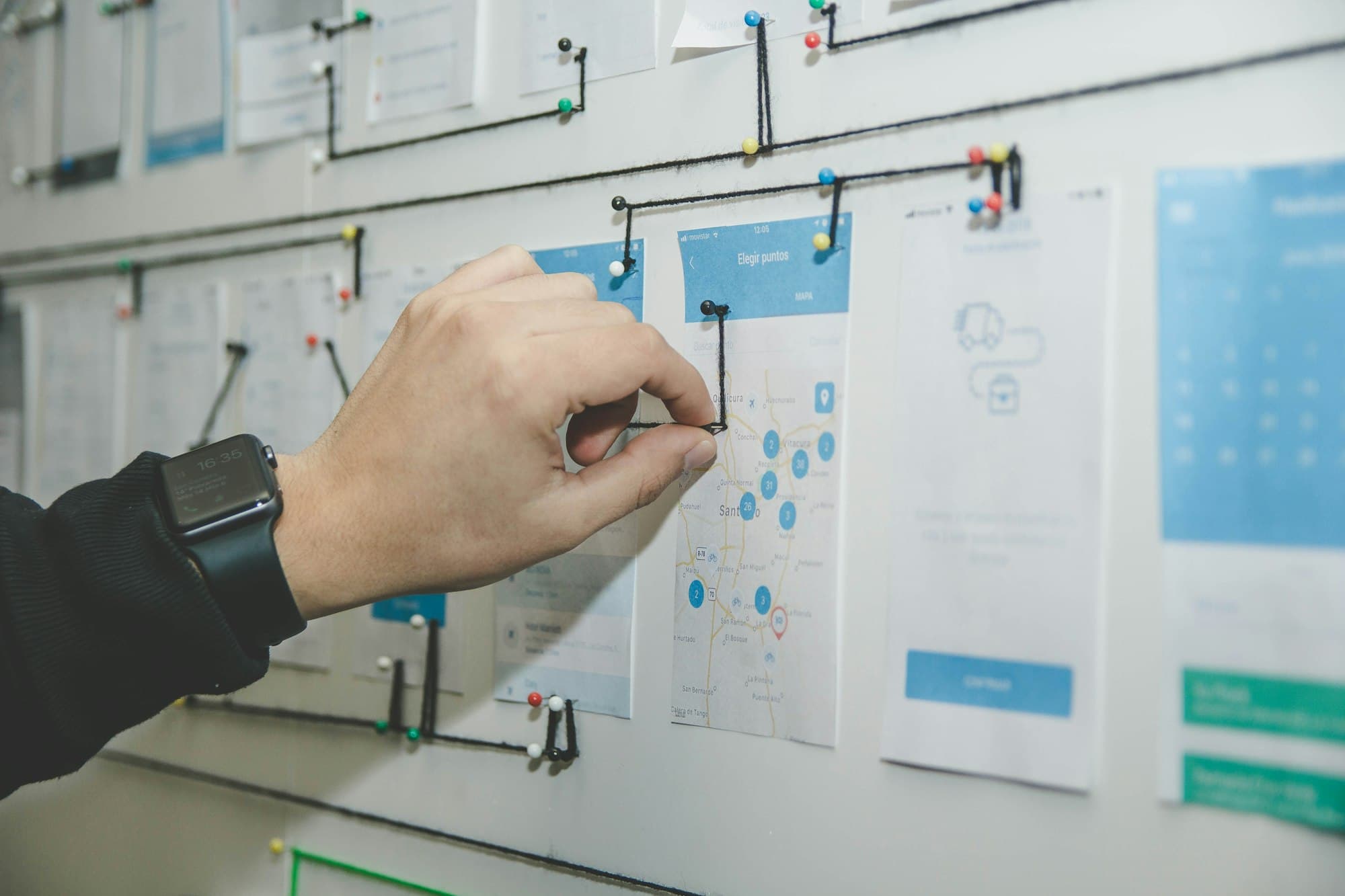 A designer mapping a user journey on a whiteboard during project planning